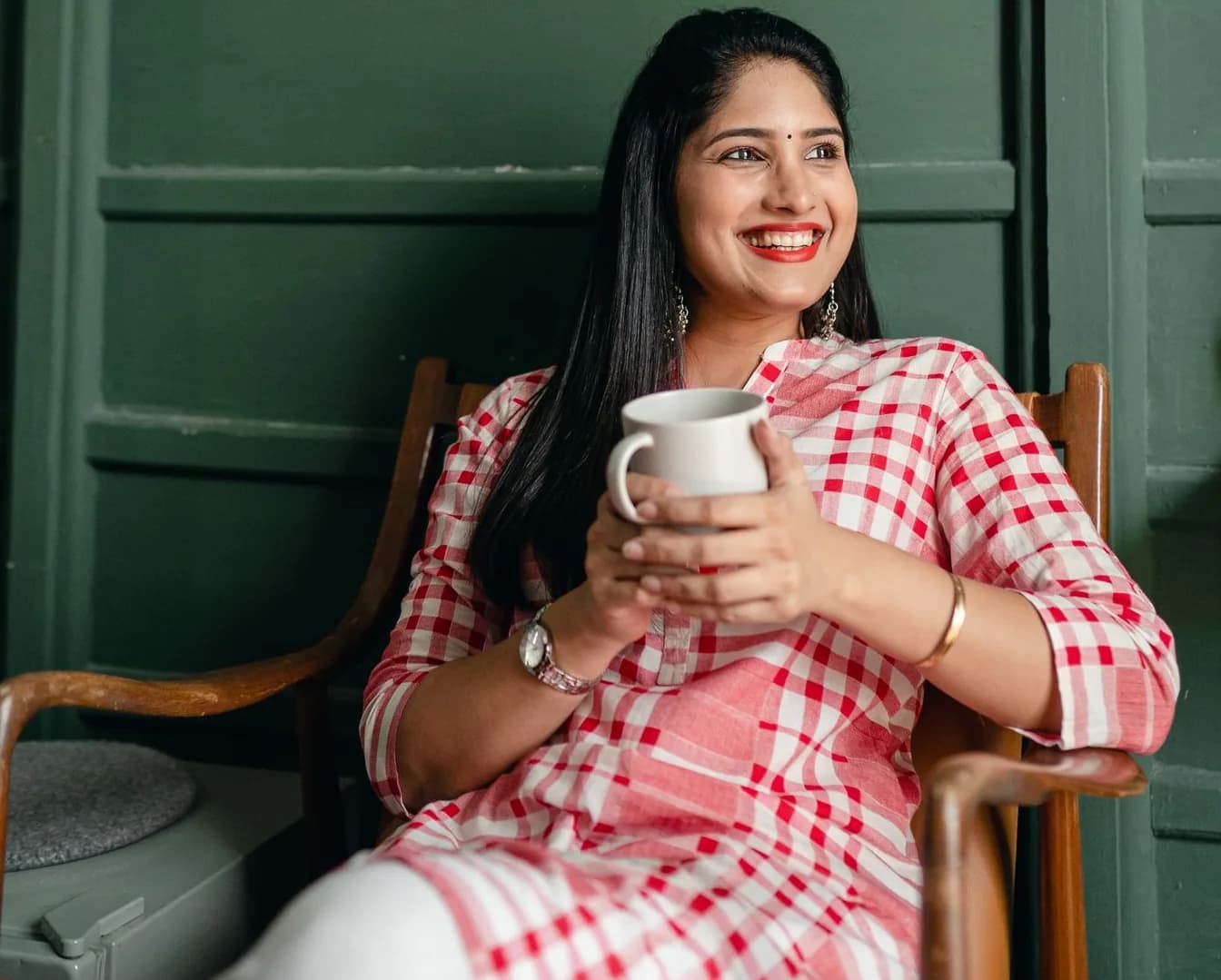 Woman smiling while holding a smartphone